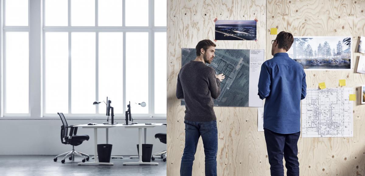 Two men making plans writing ideas on a wall